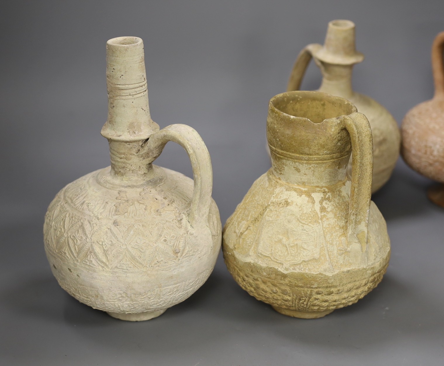 Four Islamic terracotta jugs, Middle Eastern possibly, 12th century, tallest 26cm